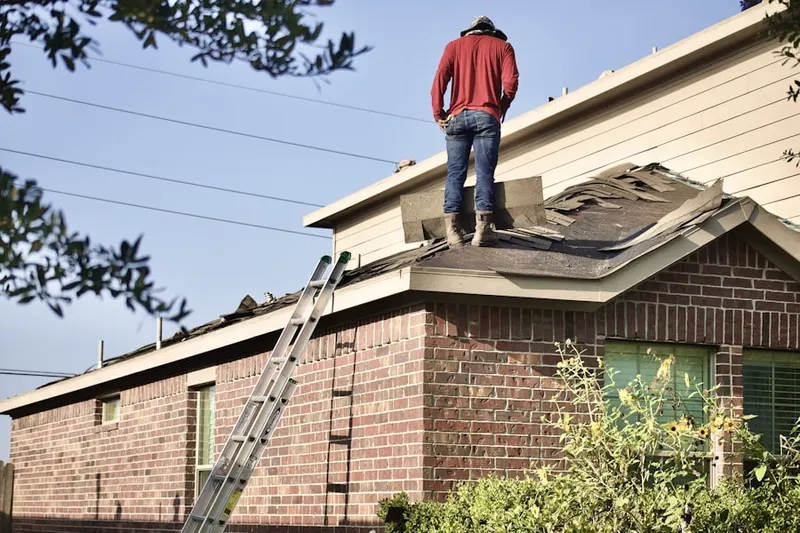 Professional roofer working on a residential roof in Cypresswood Court